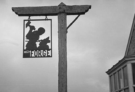 forge sign against cloudy sky