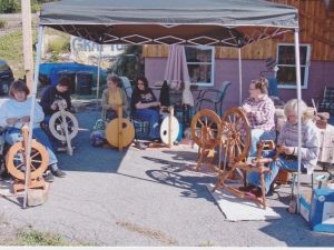 Group of women with spinning wheels