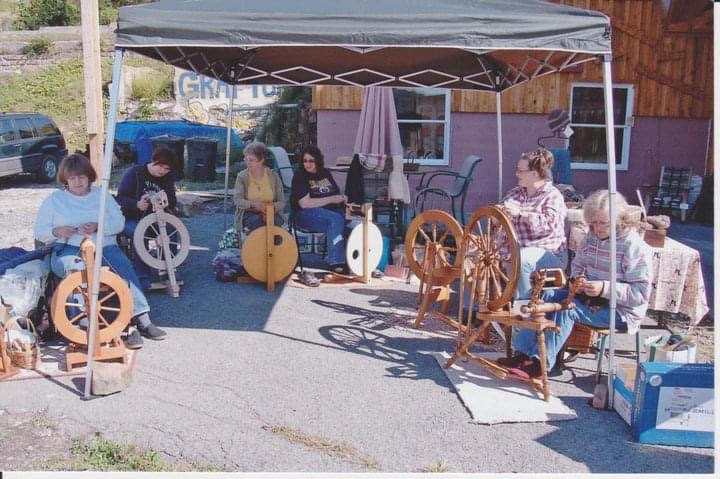 Group of women with spinning wheels